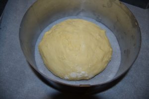 pâte déposer dans un cercle à patisserie sur une plaque recouverte de papier cuisson