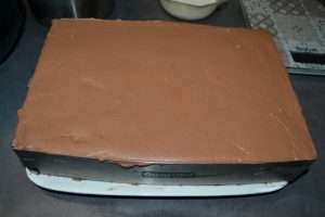 mousse chocolat étaler sur la génoise jusqu'en haut du cadre